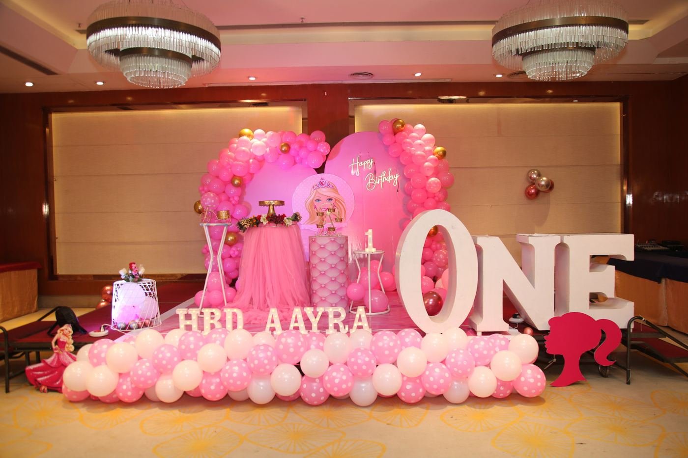 Pink first birthday stage decor with a big ONE sign